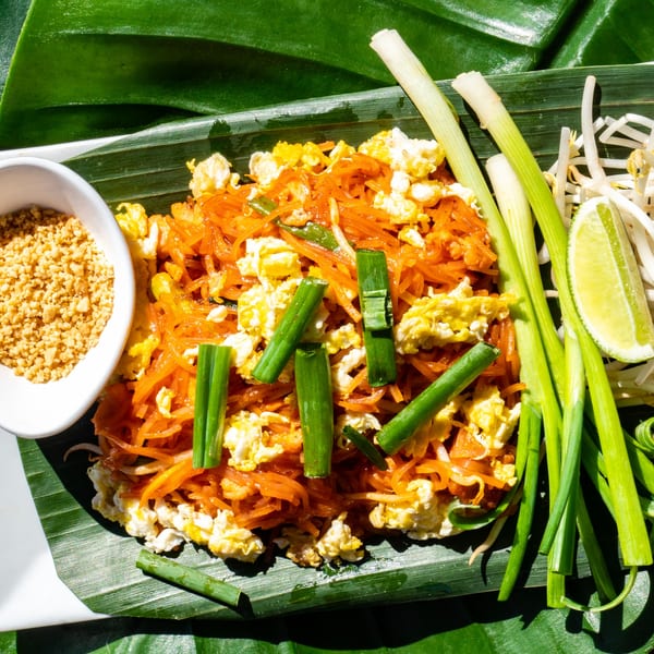 Thailicious Pad Thai with noodles, scrambled egg, green onions, bean sprouts, lime, and crushed peanuts.