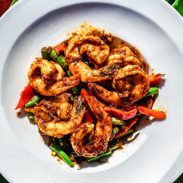 Thailicious' spicy shrimp stir-fry with green beans and red bell peppers in a white bowl.