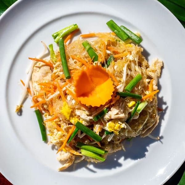 Thailicious' Pad Woon Sen with clear noodles, chicken, egg, carrots, bean sprouts, and green onions.