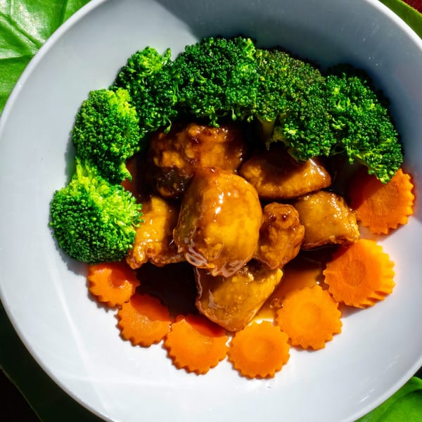 Thailicious's chicken with broccoli and carved carrots in a sweet brown sauce.